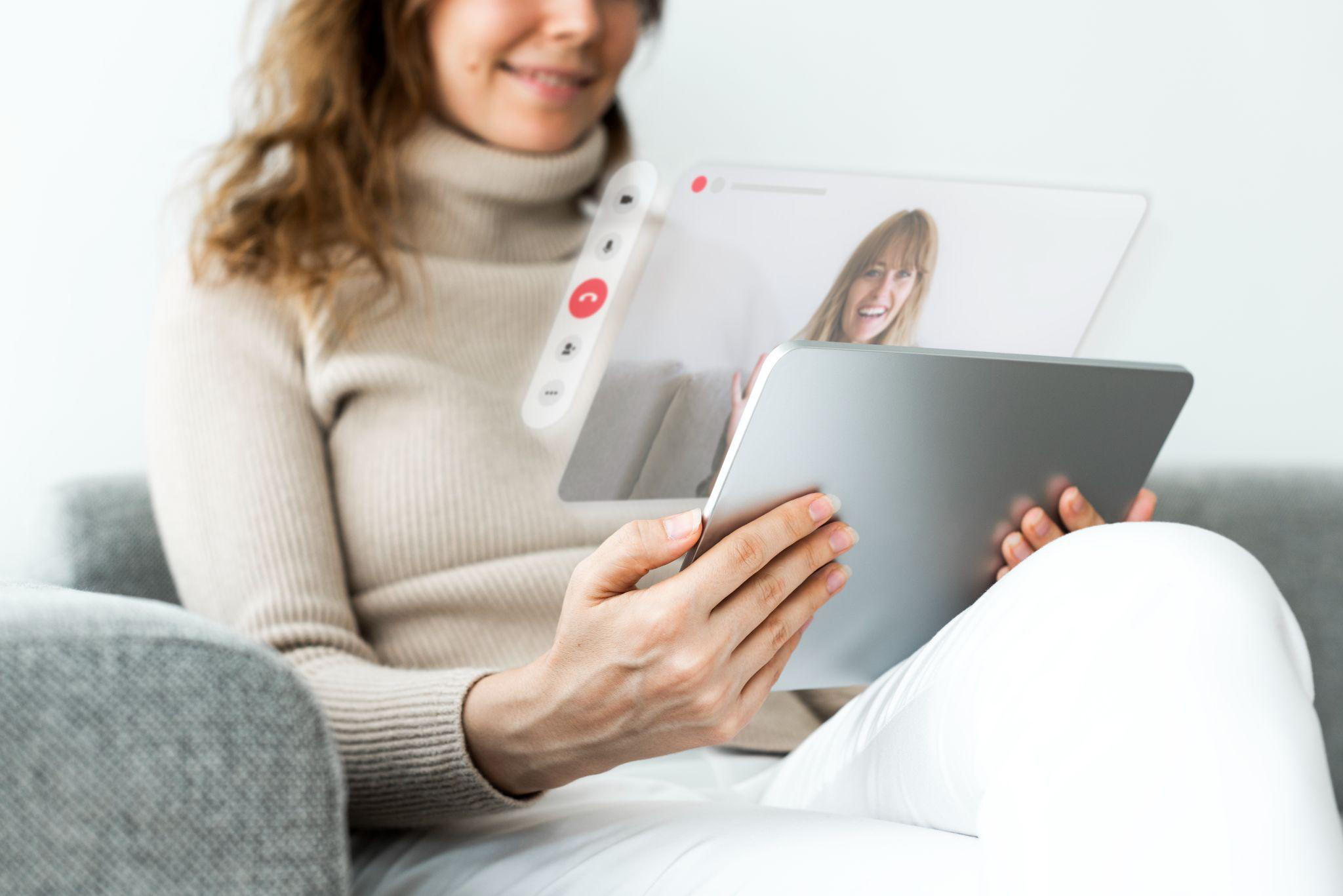 A woman using a tablet for a video call 